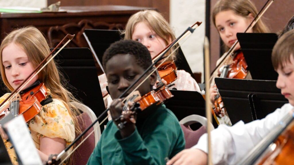 Young students violin orchestra performance